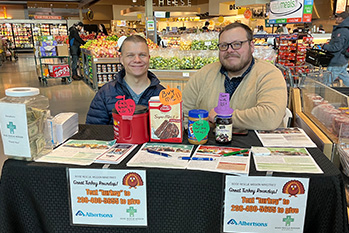 Two volunteers helping with the Turkey round up food drive