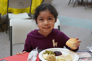 Child enjoying her free meal provided to her at a previous banquet