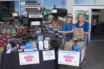 Boise Rescue Mission Ministries employees accepting food at the food drive