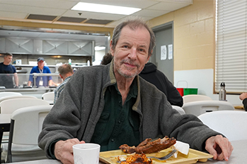Guest eating a meal served to him at Boise Rescue Mission Ministries
